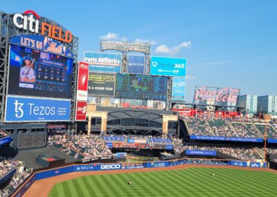 A baseball field with many fans in the stands.