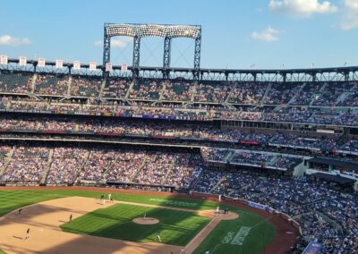 A baseball stadium with many fans in the stands.